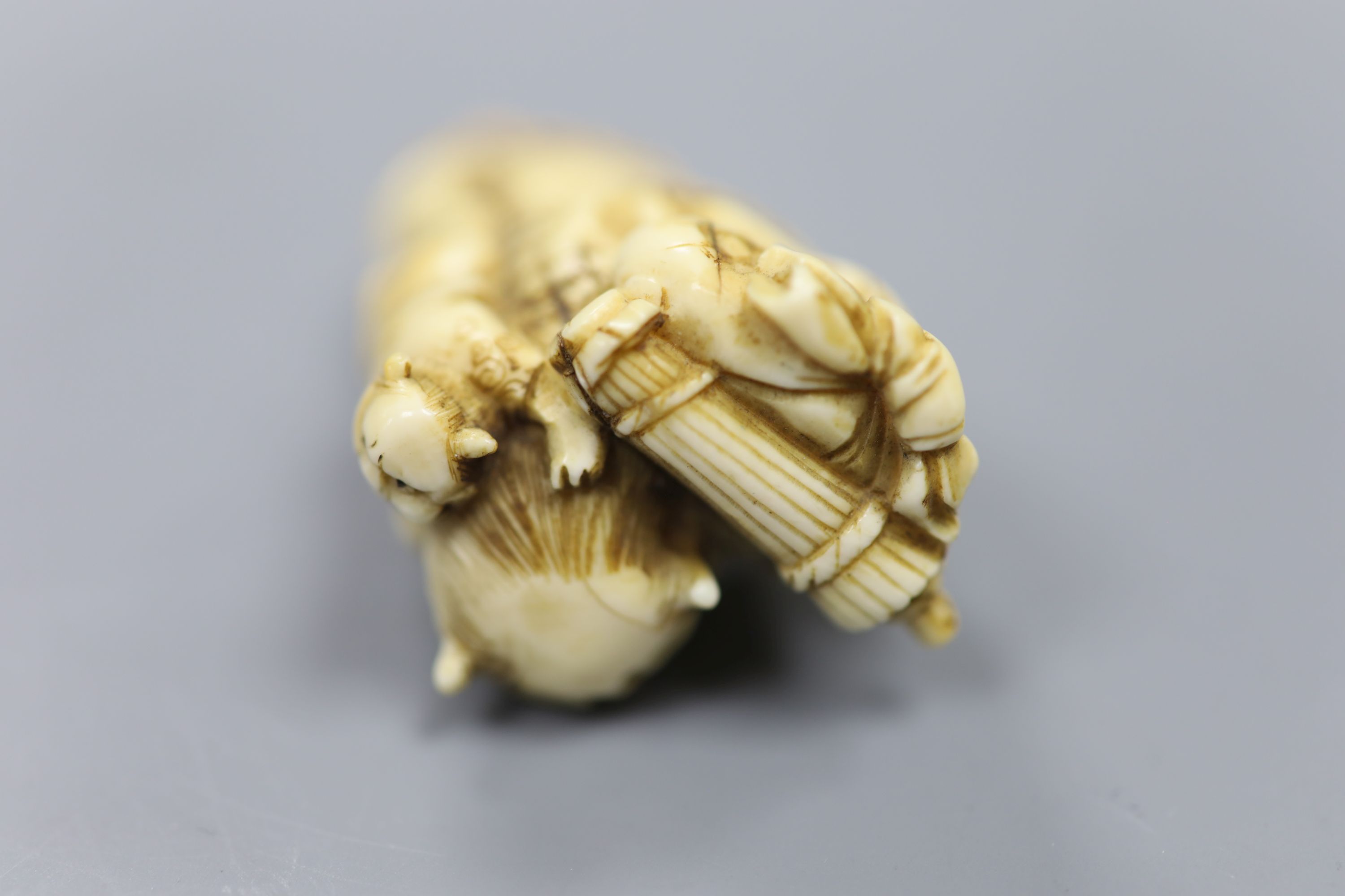 A 19th century Japanese carved ivory okimono of two oni, height 5cm